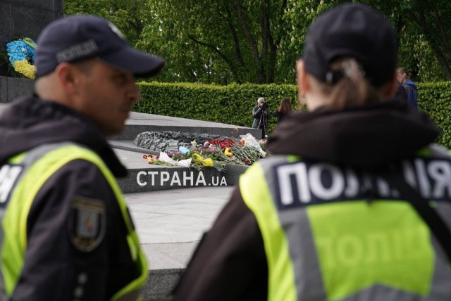 Тем временем люди несут цветы в Вечному огню в Киеве