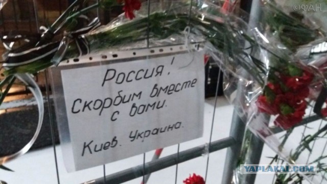 Приспущенные флаги и цветы у посольства России в Беларуси