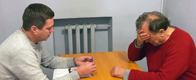Доцента Олега Соколова выводят со следственного эксперимента из квартиры на Мойке.