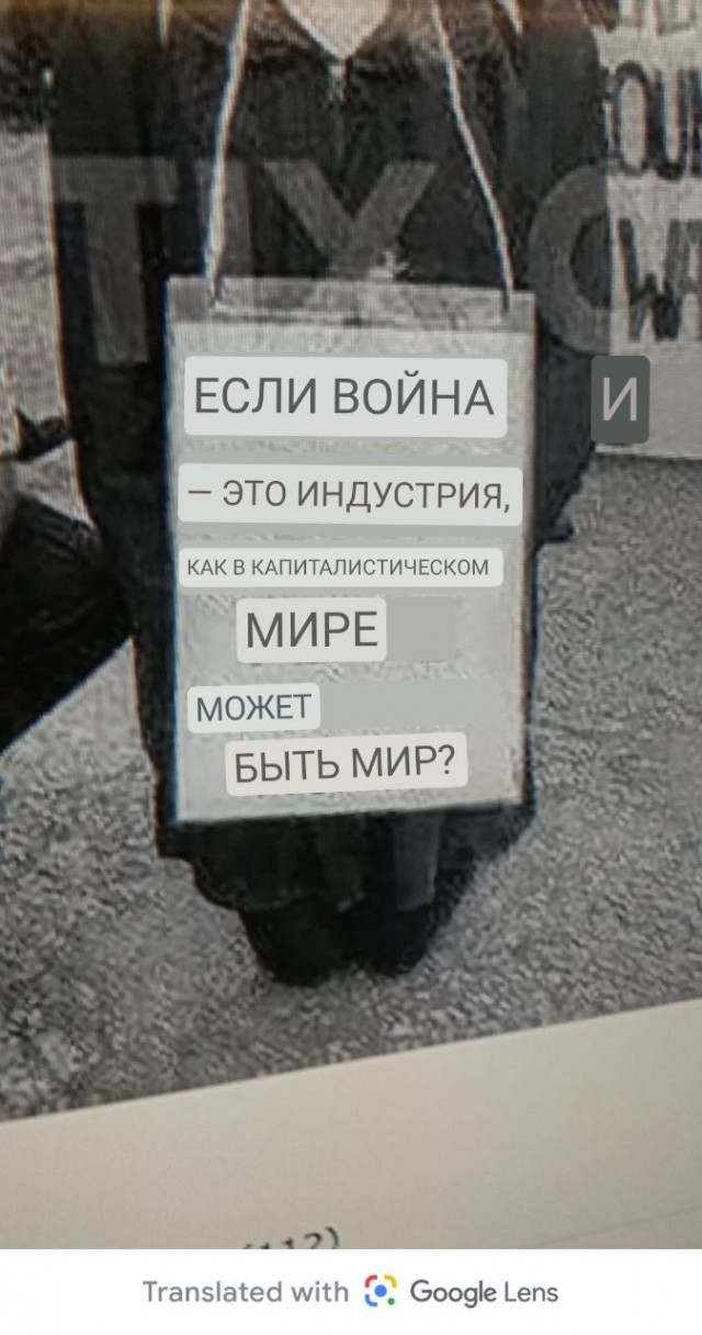 Старое фото. Надпись на плакате у пикетчицы: "Если война является индустрией, то как возможен мир при капиталистическом строе?"