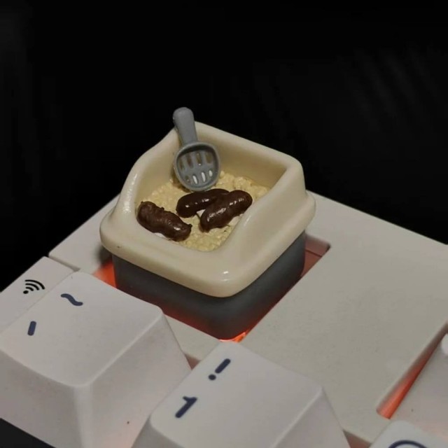 В Южной Корее продают кейкапы в виде кошачьих лотков — с совочком и «сюрпризами» внутри.